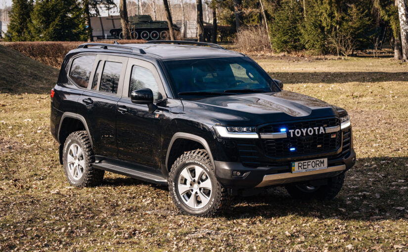 Black armored Toyota Land Cruiser 300 GR in nature