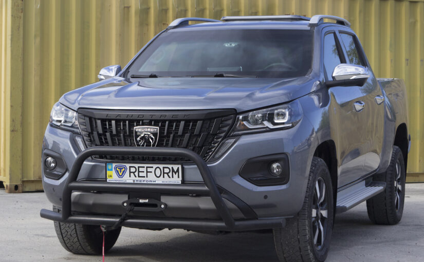 Gray armored Peugeot Landtrek REFORM PL-B6 — front and side view